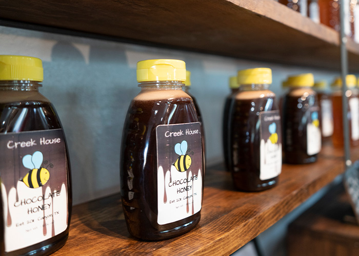 Bottles of chocolate honey on shelf