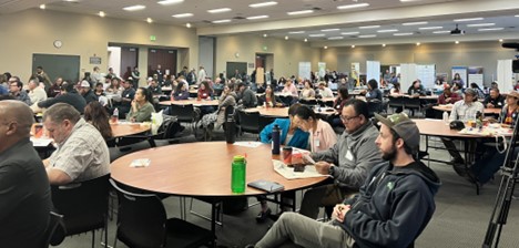 People sitting at round tables in large conference room