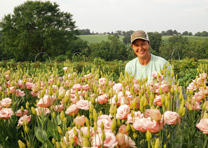 Person kneeling in flower field