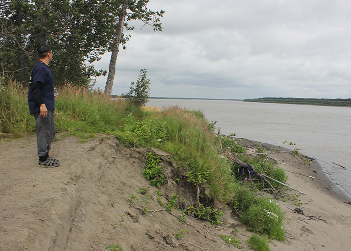 Person standing on the bank of a river