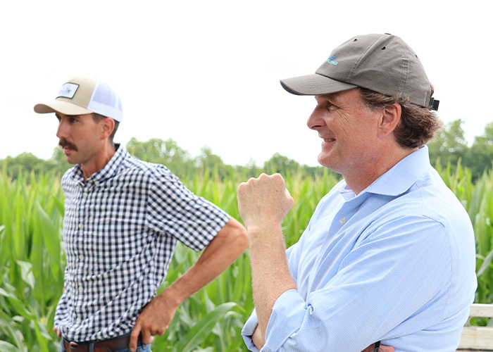 Two people standing in a field