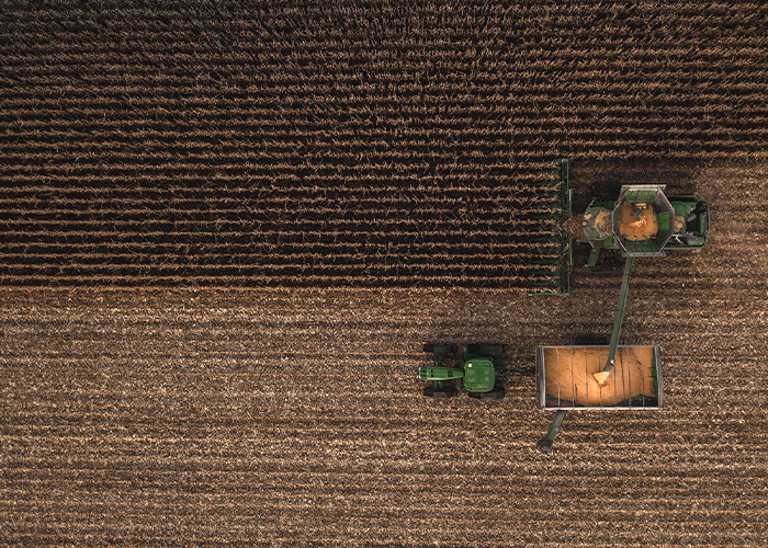 Aerial view of tractor harvesting crop