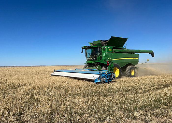 Tractor harvesting crop