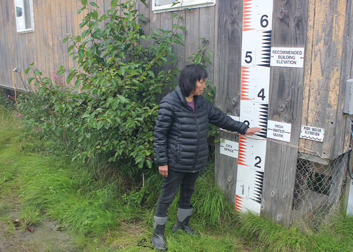 Person standing next to wall of a building