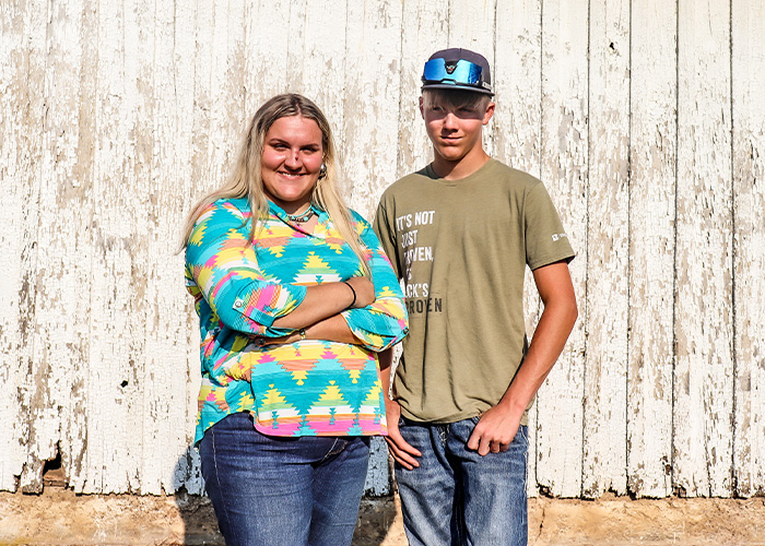 Two people standing in front of a wall