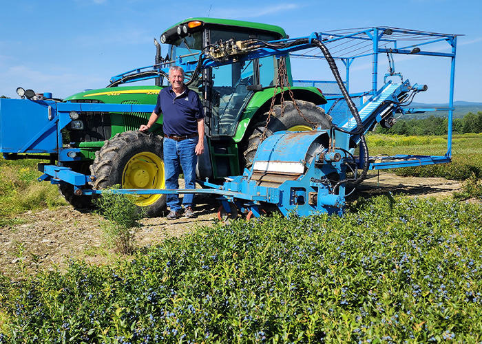 Person standing in front of tractor