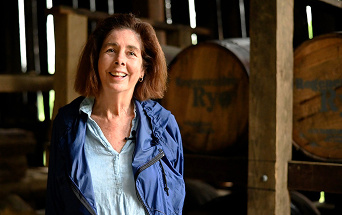 Person standing in front of barrels