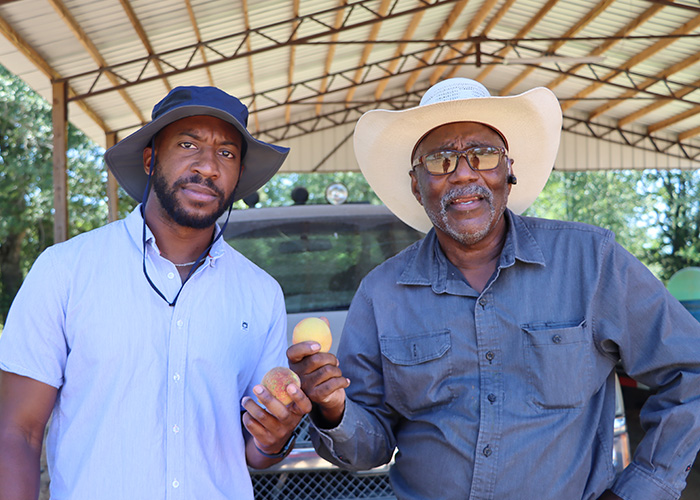 Two people holding fruit