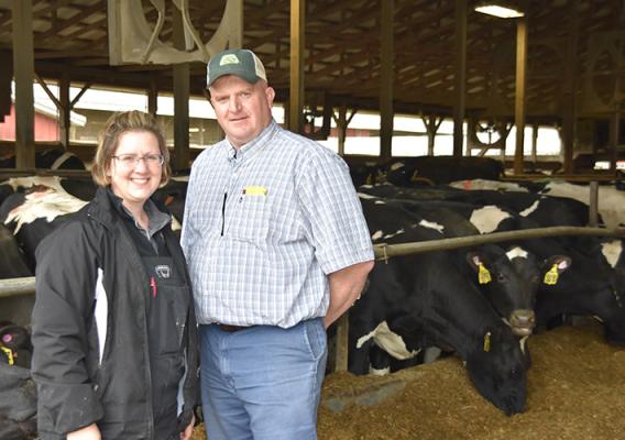 AJ and Jeanne Wormuth, operators of Half Full Dairy standing in front of the cows.
