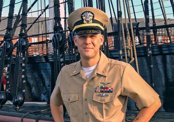 US Navy Lieutenant Daniel Longwell in front of a ship