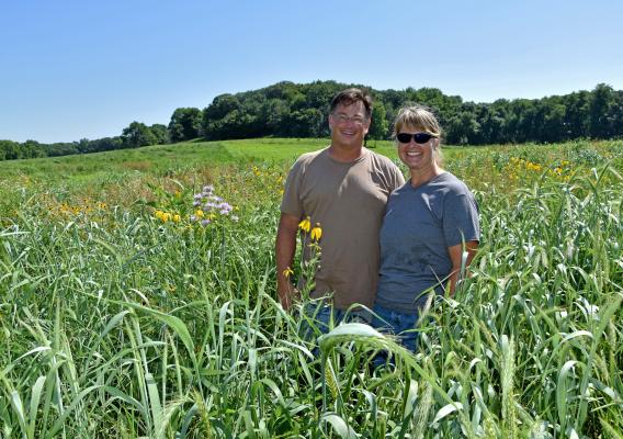 Molly and John Heaps stand on their farm