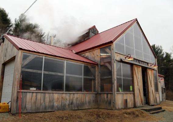 Wooden building with a red roof where maple syrup is made