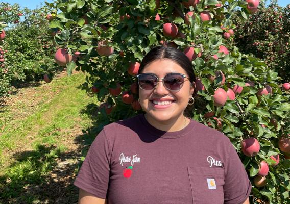 Person standing in front of an apple tree