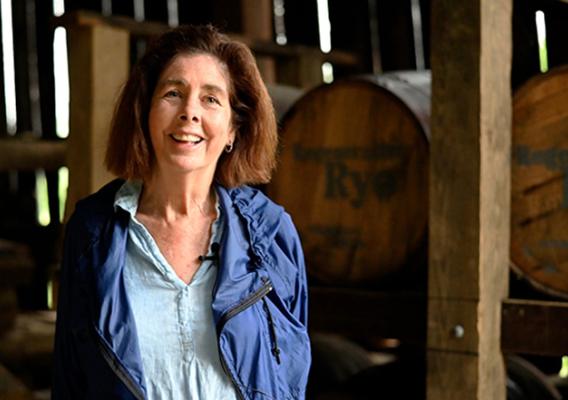 Person standing in front of barrels