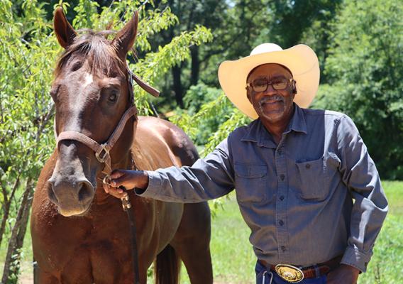 Person standing next to horse