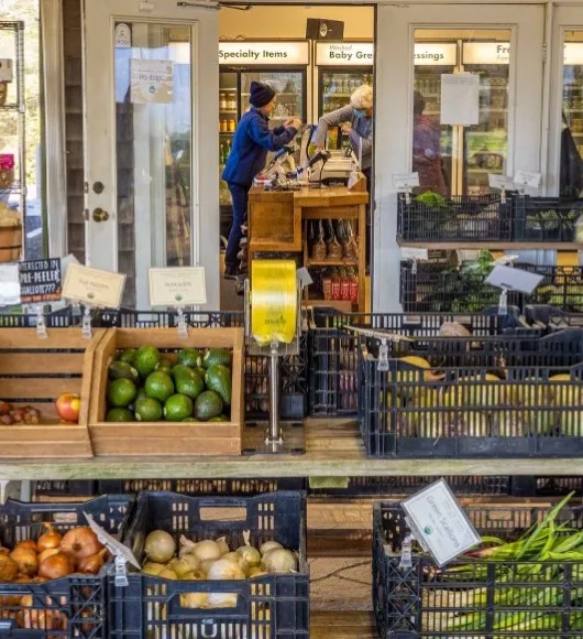 Bins of specialty produce for sale in front of a store