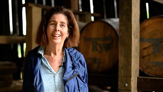 Person standing in front of barrels