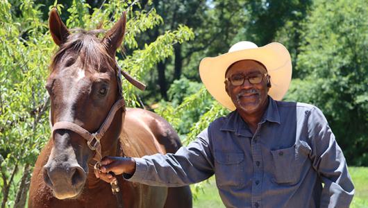 Person standing next to horse